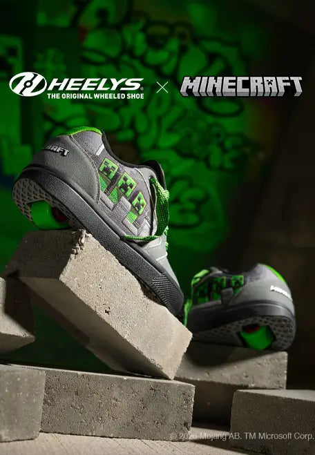 Minecraft Heelys shoes in grey and green with creeper artwork atop concrete blocks.